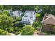 Aerial view of a charming house with lush landscaping, mature trees, and a well-manicured lawn at 3215 N Pennsylvania St, Indianapolis, IN 46205