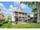 Large backyard with manicured lawn, brick patio, outdoor seating, and covered veranda at 3215 N Pennsylvania St, Indianapolis, IN 46205