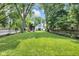 Expansive backyard with lush lawn and stylish outbuilding and tree coverage at 3215 N Pennsylvania St, Indianapolis, IN 46205