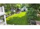 Aerial view of the backyard with an outdoor lounge area, a detached garage, and a well-maintained lawn at 3215 N Pennsylvania St, Indianapolis, IN 46205
