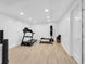 Basement featuring wood-look flooring, a treadmill, punching bag, and weight rack ready for a home gym at 3215 N Pennsylvania St, Indianapolis, IN 46205