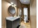 Modern bathroom with dark vanity, concrete sink, and neutral walls at 3215 N Pennsylvania St, Indianapolis, IN 46205