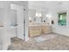 Bright bathroom features double vanities and brick flooring at 3215 N Pennsylvania St, Indianapolis, IN 46205