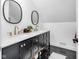 Modern bathroom with dual vanities, marble countertops, and sleek black fixtures, offering a touch of elegance at 3215 N Pennsylvania St, Indianapolis, IN 46205