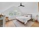 Serene bedroom with natural light, ceiling fan, and neutral decor for a relaxing atmosphere at 3215 N Pennsylvania St, Indianapolis, IN 46205