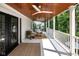 Inviting covered porch with wood plank ceiling, fan, and comfortable seating area, perfect for outdoor relaxation at 3215 N Pennsylvania St, Indianapolis, IN 46205