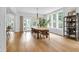 Bright dining room with hardwood floors, modern chandelier, and a view to the outdoor space at 3215 N Pennsylvania St, Indianapolis, IN 46205
