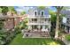 Charming three-story house with multiple balconies, a brick patio with seating, and a spacious lawn at 3215 N Pennsylvania St, Indianapolis, IN 46205