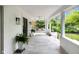 Spacious front porch with concrete floor, white columns and ceiling, and a comfortable hanging daybed at 3215 N Pennsylvania St, Indianapolis, IN 46205