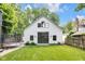 An exterior shot of the detached garage with a modern design and glass doors, surrounded by a well-maintained lawn at 3215 N Pennsylvania St, Indianapolis, IN 46205
