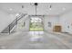 Garage interior featuring an open garage door to the yard with a staircase and ample storage space at 3215 N Pennsylvania St, Indianapolis, IN 46205