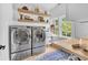 Bright laundry room with modern appliances, open shelving, butcher block counter, and natural light at 3215 N Pennsylvania St, Indianapolis, IN 46205
