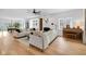 Open-concept living room with hardwood floors, a modern ceiling fan, and a cozy fireplace with stylish decor at 3215 N Pennsylvania St, Indianapolis, IN 46205