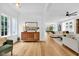 Bright open-concept living room with hardwood floors, a modern sideboard, and an airy, inviting atmosphere at 3215 N Pennsylvania St, Indianapolis, IN 46205