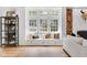 Bright living room with custom window seat, hardwood floors, a cozy fireplace, and stylish decor at 3215 N Pennsylvania St, Indianapolis, IN 46205