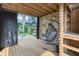 Relaxing outbuilding with wooden deck, hanging chair, and view of the metal tub at 3215 N Pennsylvania St, Indianapolis, IN 46205