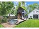 Stylish outbuilding with adjacent brick patio and metal tub, offers a unique outdoor escape at 3215 N Pennsylvania St, Indianapolis, IN 46205