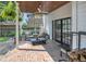 Inviting outdoor patio with brick flooring, comfortable seating, and a ceiling fan at 3215 N Pennsylvania St, Indianapolis, IN 46205