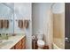 Well-lit bathroom featuring a vanity, toilet and a shower/tub combination with a curtain at 350 N Meridian St # A303, Indianapolis, IN 46204