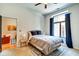Bright bedroom with large window, neutral decor, and ceiling fan at 350 N Meridian St # A303, Indianapolis, IN 46204