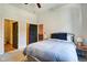 Bright bedroom features a ceiling fan, neutral walls, and a queen bed with dark blue pillows at 350 N Meridian St # A303, Indianapolis, IN 46204