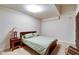 Cozy bedroom offering a comfortable bed, neutral carpet, side table, and a reading lamp at 350 N Meridian St # A303, Indianapolis, IN 46204