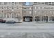 The property's brick exterior includes covered parking and a walkway, all in an urban setting at 350 N Meridian St # A303, Indianapolis, IN 46204