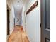 A light-filled hallway features wood floors, coat rack, and neutral walls at 350 N Meridian St # A303, Indianapolis, IN 46204
