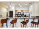 Open kitchen bar with counter seating, stainless appliances, and wood cabinets at 350 N Meridian St # A303, Indianapolis, IN 46204