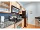 Close up of modern kitchen with tile backsplash and stainless steel appliances at 350 N Meridian St # A303, Indianapolis, IN 46204
