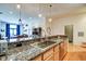 Open kitchen with granite countertops, stainless appliances and access to other living spaces at 350 N Meridian St # A303, Indianapolis, IN 46204