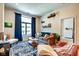 Bright living room featuring large window, hardwood floors, patterned rug, and comfortable sofa at 350 N Meridian St # A303, Indianapolis, IN 46204