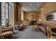 Comfortable lobby with a leather sofa, armchairs, and a piano at 350 N Meridian St # A303, Indianapolis, IN 46204