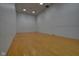 Spacious racquetball court with hardwood floors and white walls, illuminated by overhead lighting at 350 N Meridian St # A303, Indianapolis, IN 46204