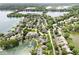Aerial view of waterfront houses on a lake, surrounded by lush greenery and a clear blue sky at 3535 Clearwater Cir, Indianapolis, IN 46240