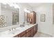 Bathroom features double sinks, granite counters, and updated fixtures for a modern aesthetic at 3535 Clearwater Cir, Indianapolis, IN 46240