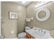 Powder room with decorative mirror, vanity, and neutral paint, creating a serene and inviting space at 3535 Clearwater Cir, Indianapolis, IN 46240