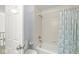 Bathroom featuring a shower with tile surround and a decorative curtain plus toilet and partial door at 3535 Clearwater Cir, Indianapolis, IN 46240