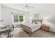 Calm bedroom featuring a wood-frame bed, neutral colors, and plenty of natural light at 3535 Clearwater Cir, Indianapolis, IN 46240