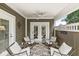Inviting covered patio with ceiling fan and comfortable white wicker seating at 3535 Clearwater Cir, Indianapolis, IN 46240