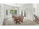 Inviting dining area with a glass table, natural light, and a door leading to an outdoor space at 3535 Clearwater Cir, Indianapolis, IN 46240