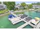 Waterfront view of a dock featuring multiple boats with various colored coverings on a sunny day at 3535 Clearwater Cir, Indianapolis, IN 46240