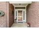 Inviting entryway with brick surround, decorative wreath and planters at 3535 Clearwater Cir, Indianapolis, IN 46240