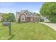 Lovely two-story home with brick accents, green lawn, and landscaped flower beds in the front yard at 3535 Clearwater Cir, Indianapolis, IN 46240