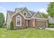 Charming brick home with well-manicured lawn and attached two-car garage at 3535 Clearwater Cir, Indianapolis, IN 46240