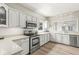 Well-lit kitchen offers stainless steel appliances, white cabinets, and a functional layout at 3535 Clearwater Cir, Indianapolis, IN 46240