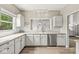 Bright kitchen boasts white cabinetry, stainless steel appliances, and ample counter space at 3535 Clearwater Cir, Indianapolis, IN 46240