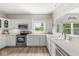 Spacious kitchen featuring stainless steel appliances, white cabinetry, and a bright, airy atmosphere at 3535 Clearwater Cir, Indianapolis, IN 46240