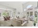 Bright living room with tall windows, comfortable seating, and seamless connection to the dining area at 3535 Clearwater Cir, Indianapolis, IN 46240