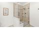 Modern tiled shower with glass enclosure and built-in shelving for a luxurious experience at 3535 Clearwater Cir, Indianapolis, IN 46240